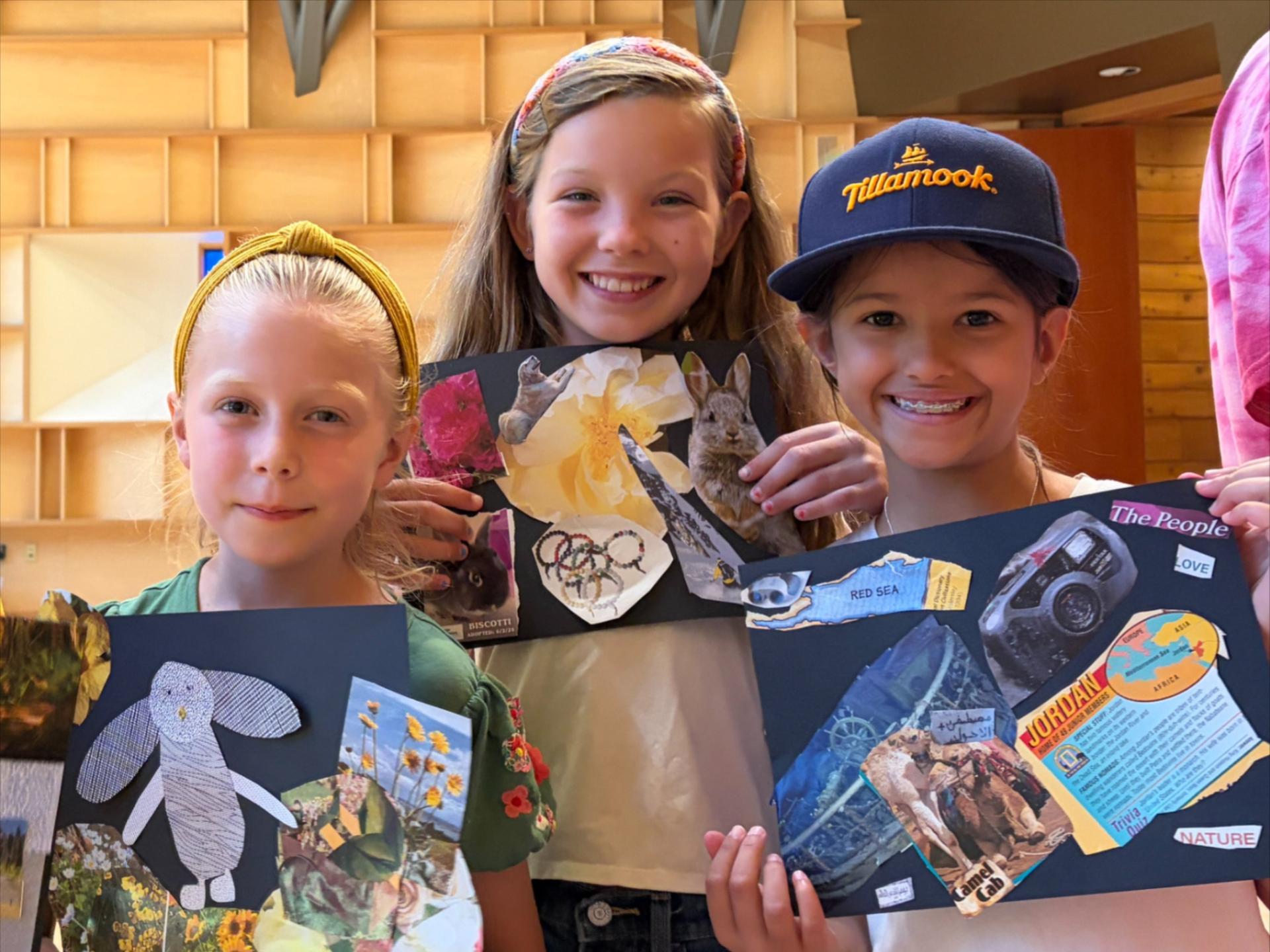 3 girl summer camp kids showing off their artwork during the Creativity Camp with WRI and ICCA.