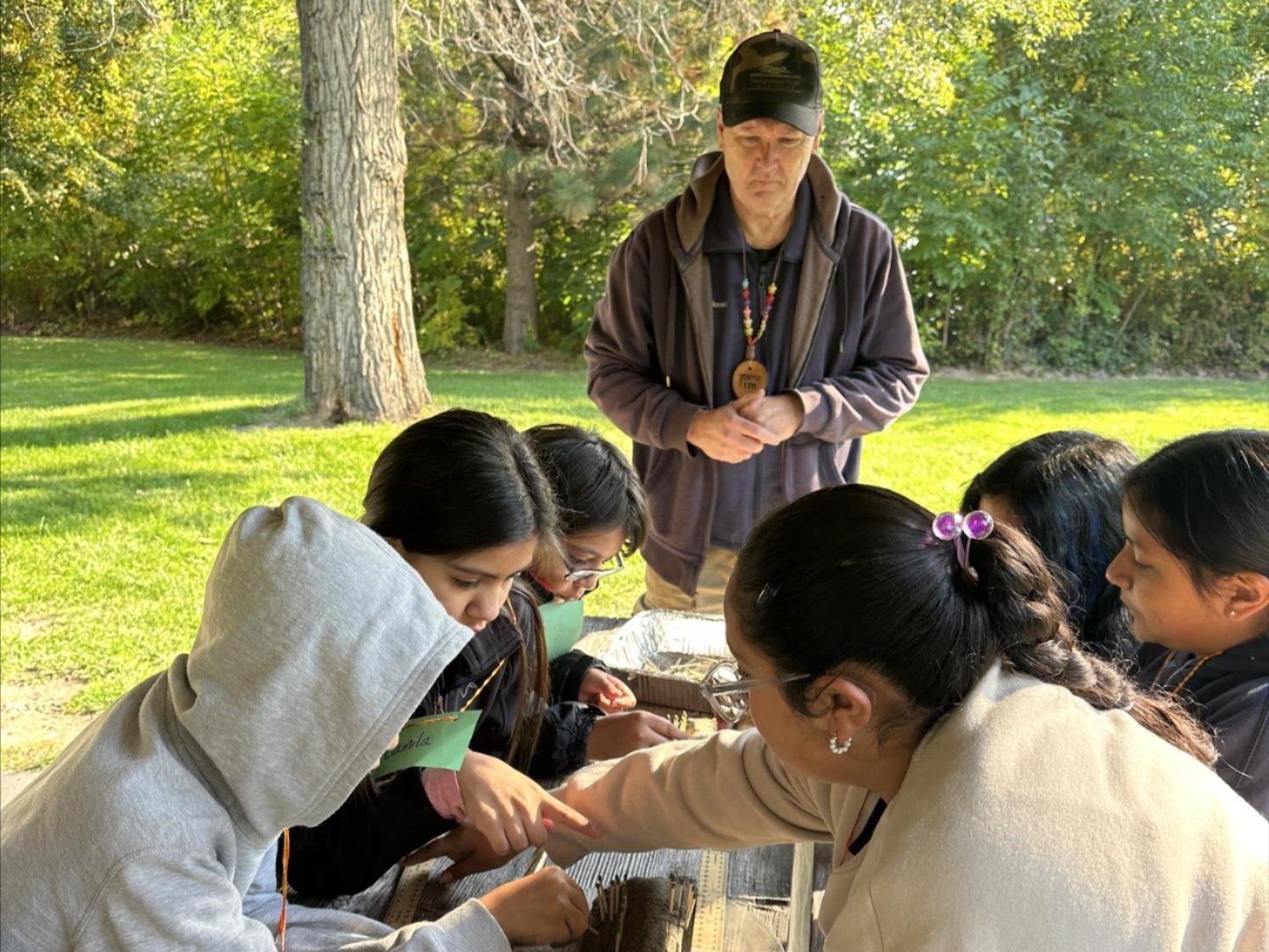 A volunteer supervising over a Field Day lesson at a state park.