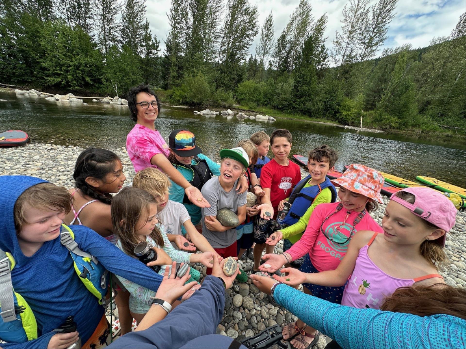 Circle of River Wild youth campers standing beside the Wenatchee River.