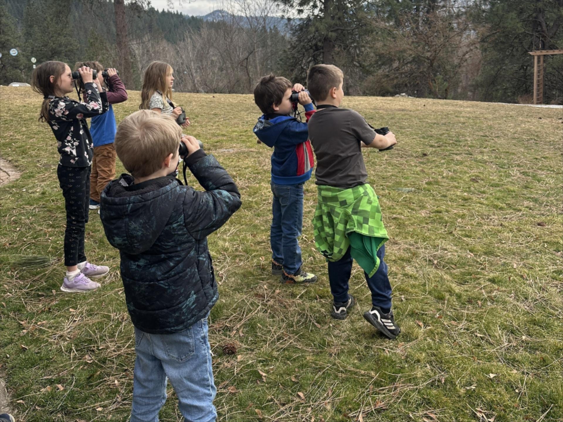 2026 Winter WRI After School Program kids looking for birds with binoculars.