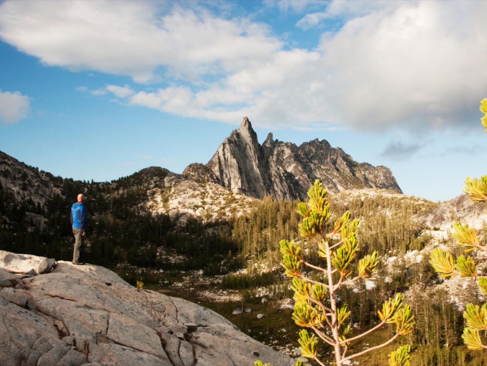 Man standing on a rock looking at Prusik Peak in the Enchantments.