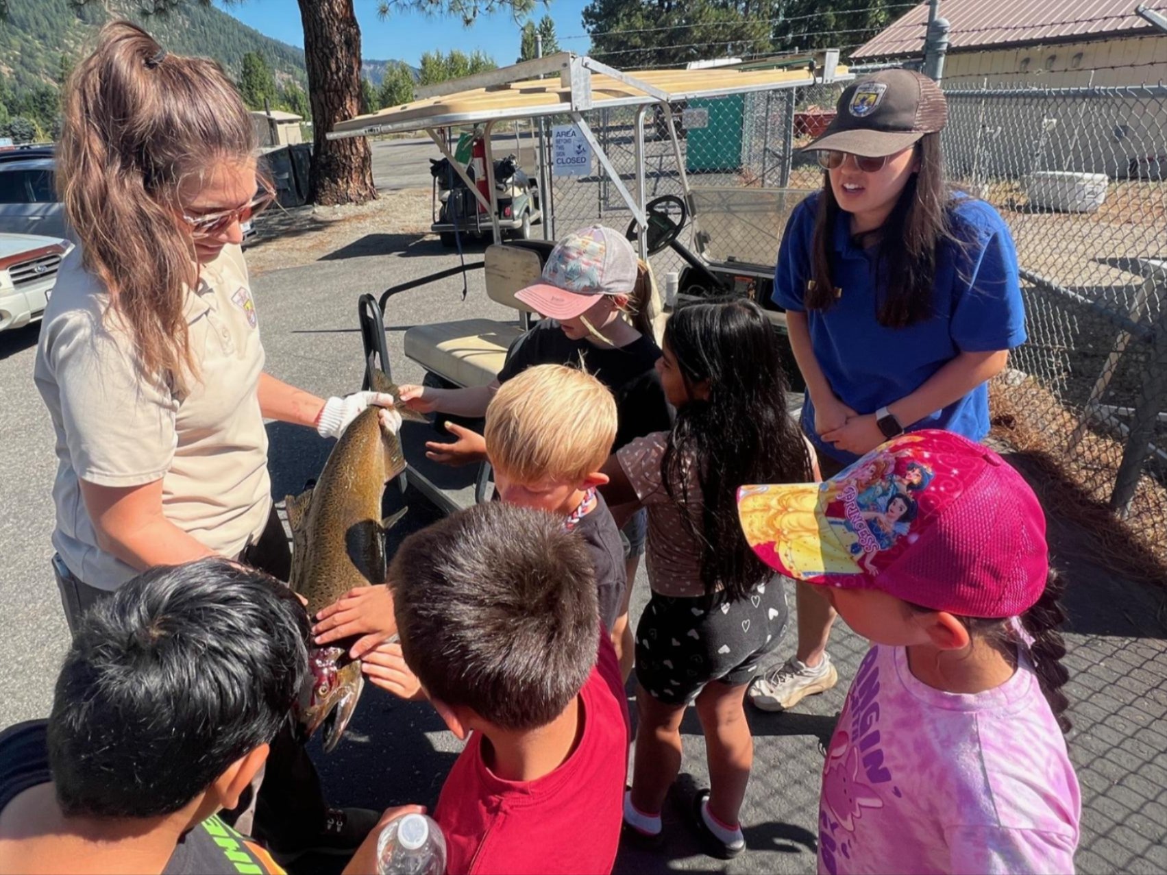 Wenatchee River Institute Summer After School Program with a local school. Kids standing around a fish.