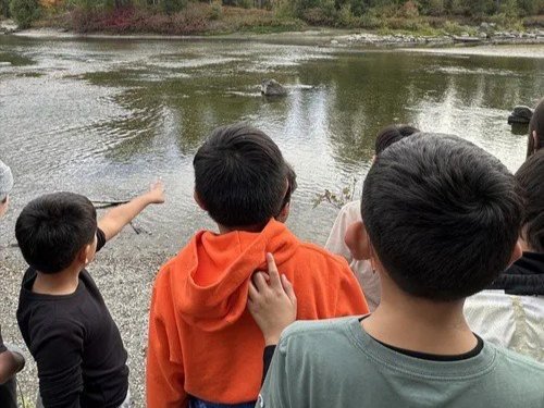 WRI Educator, Mikey doing an education birding activity with a student.