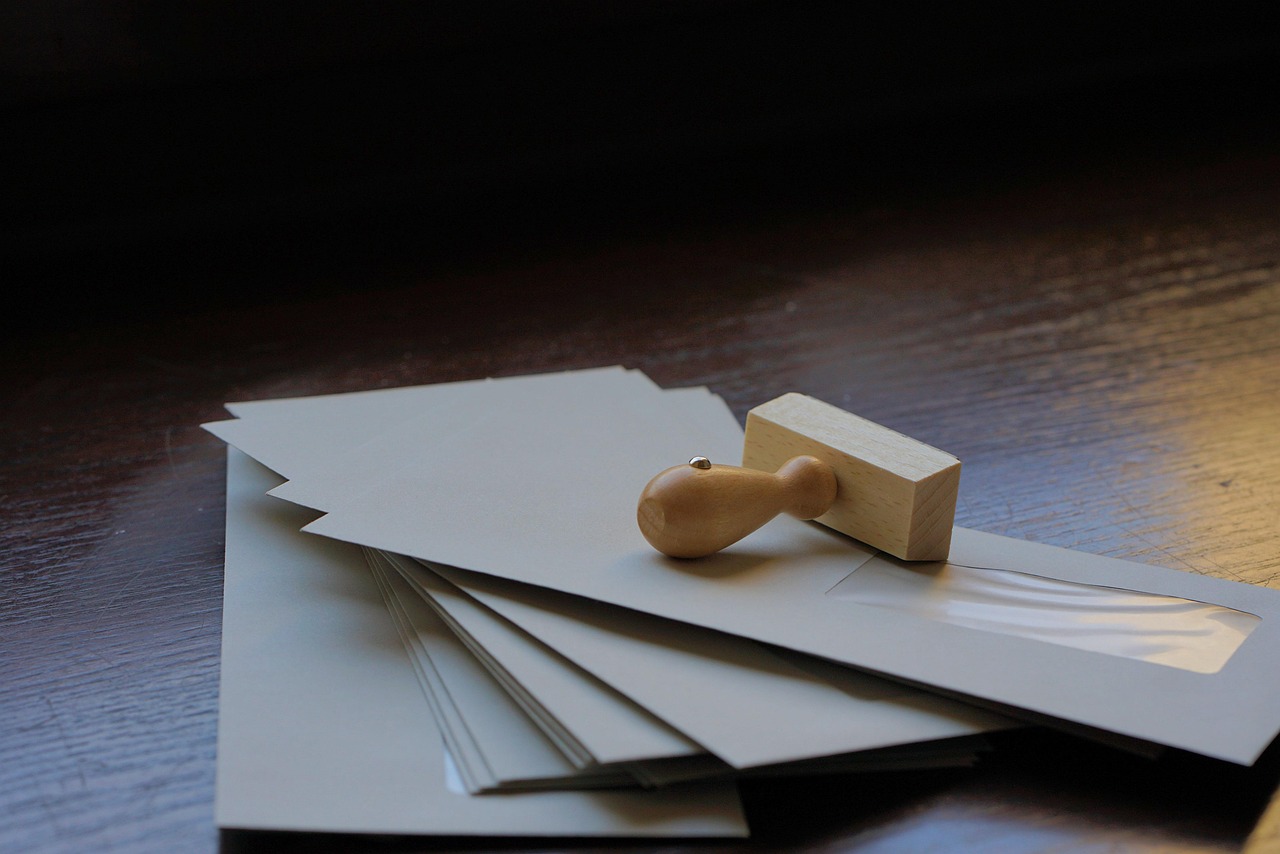 Picture of stacked envelopes and a stamp.